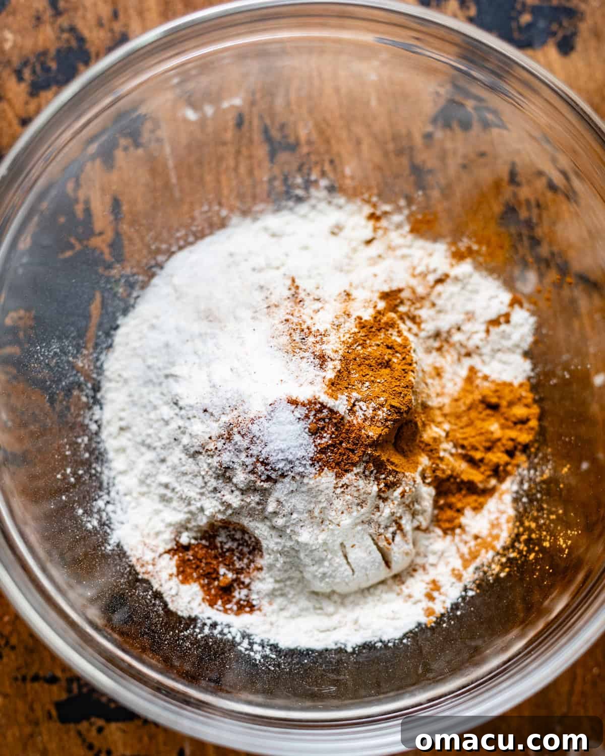 Dry ingredients, including flour, kosher salt, cinnamon, and baking powder, perfectly whisked together in a separate bowl.