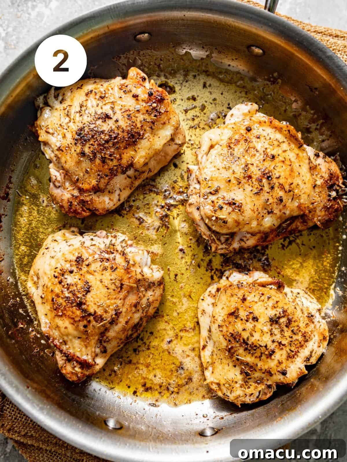 seared chicken thighs in a skillet.