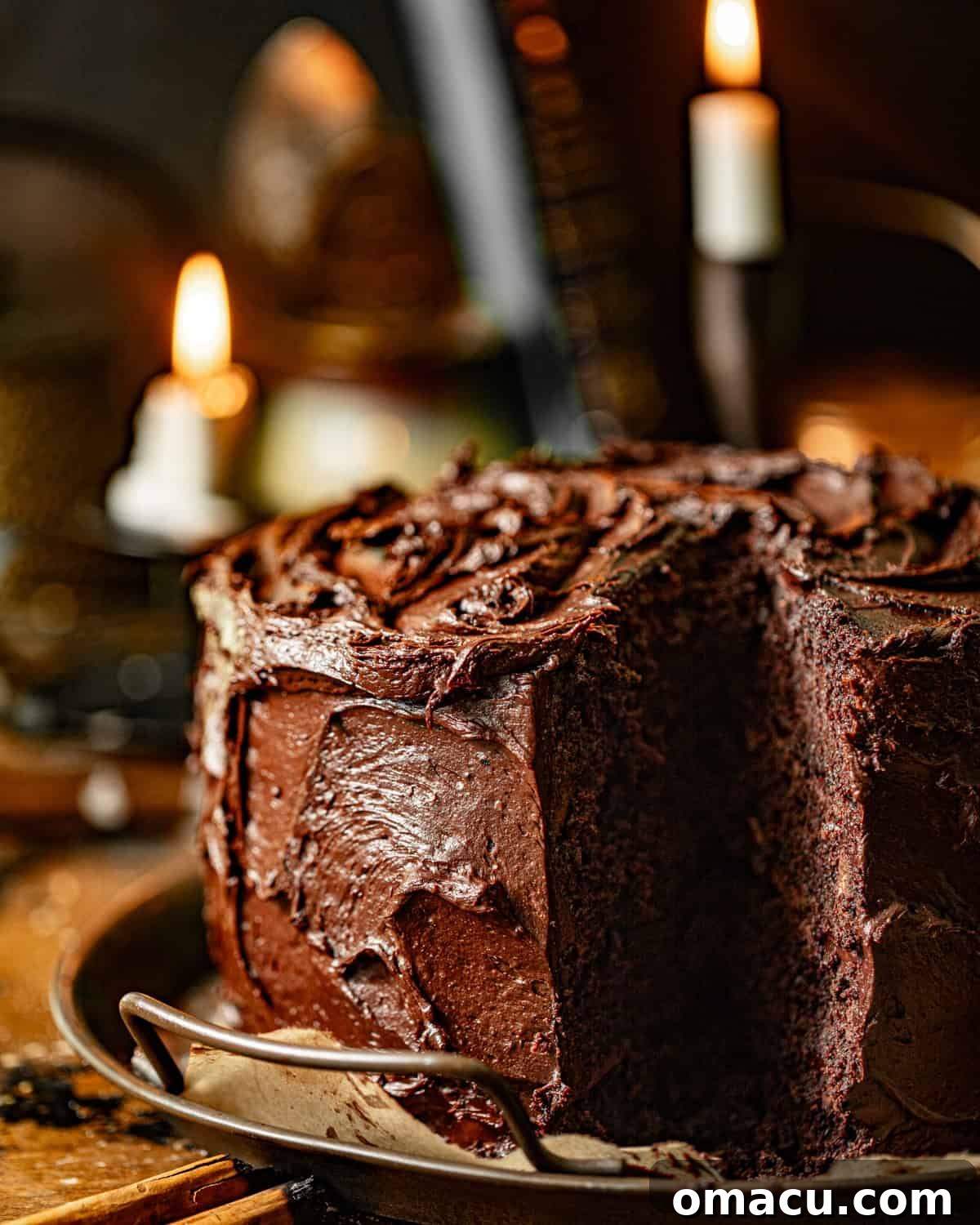 A slice of Matilda's chocolate cake taken out, revealing its moist layers and rich frosting, on a serving tray.