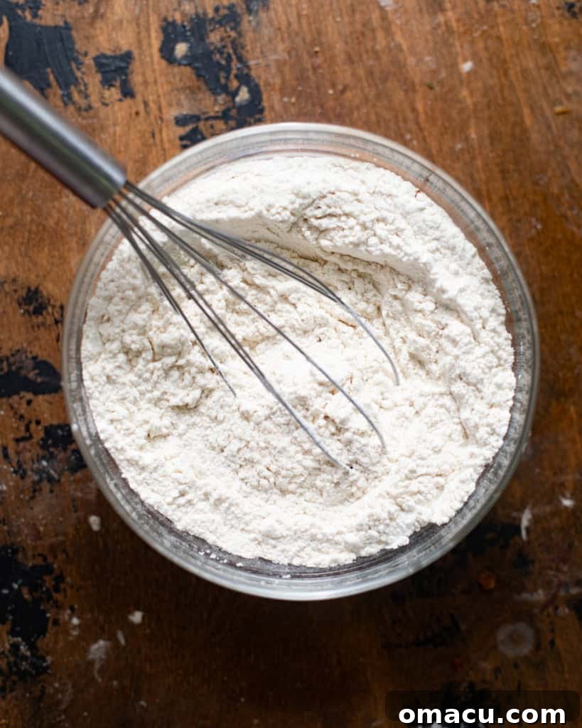 Dry ingredients mixed together in a bowl, including cake flour, cocoa powder, baking powder, and salt.