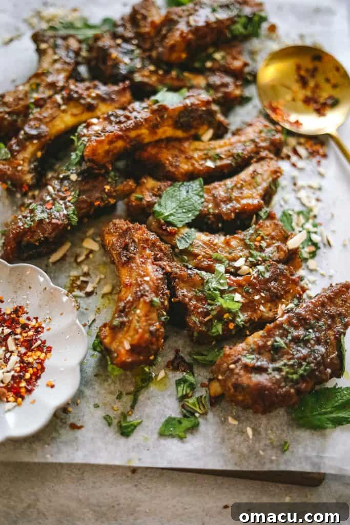 Close-up of braised ribs, glistening with peanut curry sauce