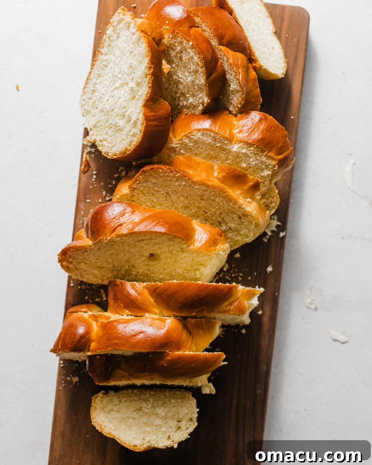 challah bread cut into thick slices on a cutting board.
