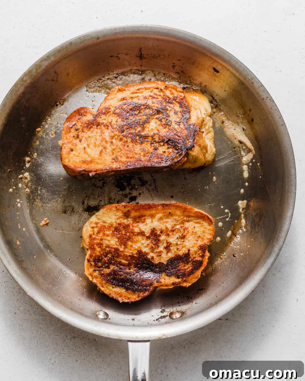 french toast cooking in a skillet.