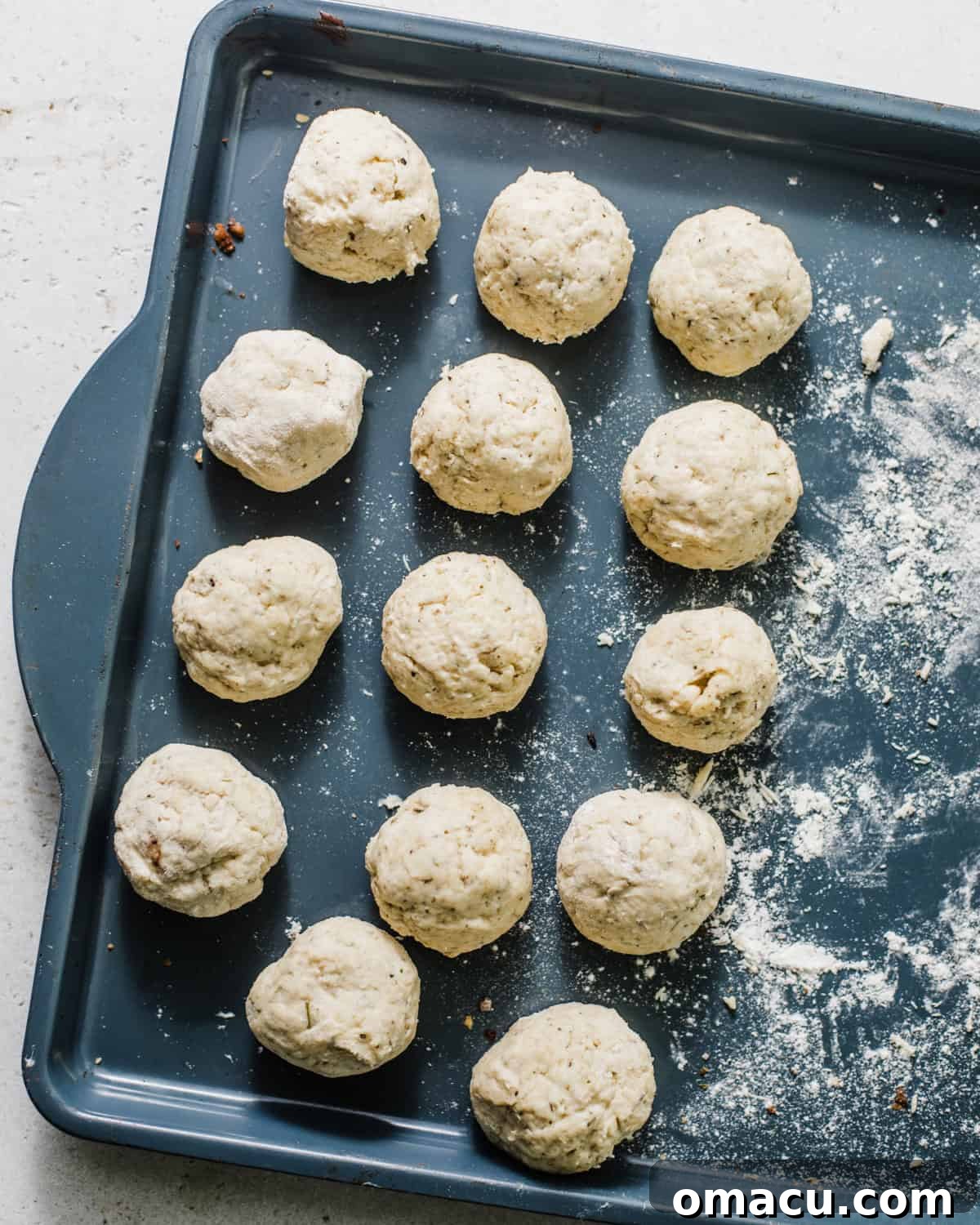 dumplings on a baking sheet rolled into a ball. 