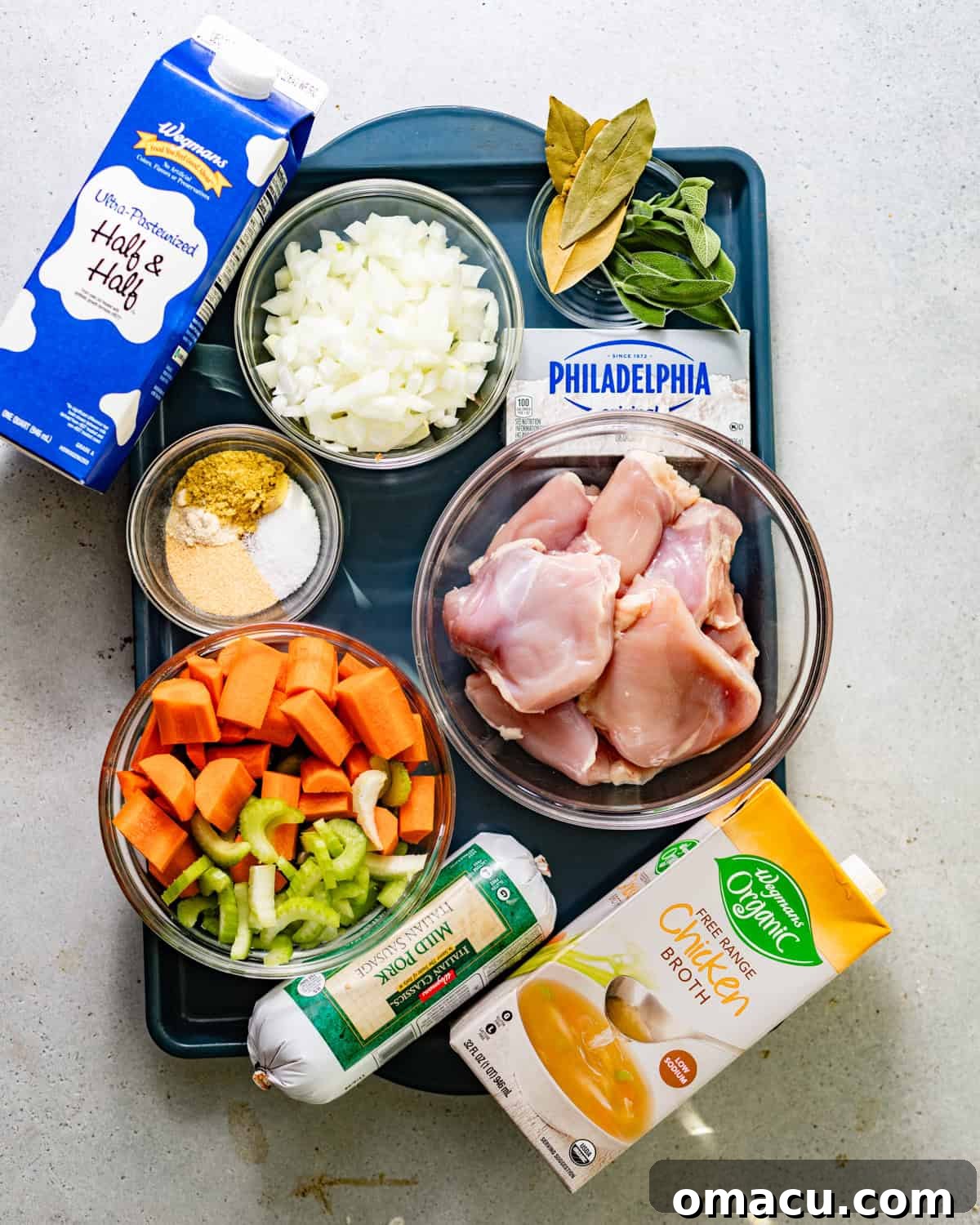 ingredients to make chicken and dumplings -chicken, chicken broth, half and half, onion, garlic, celery ,carrots, fresh sage, bay leaves, sausage, seasonings, and cream cheese.