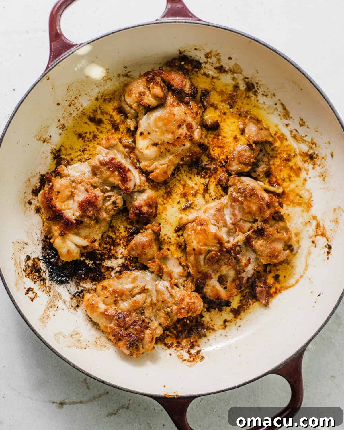 seared chicken thighs in a dutch oven.