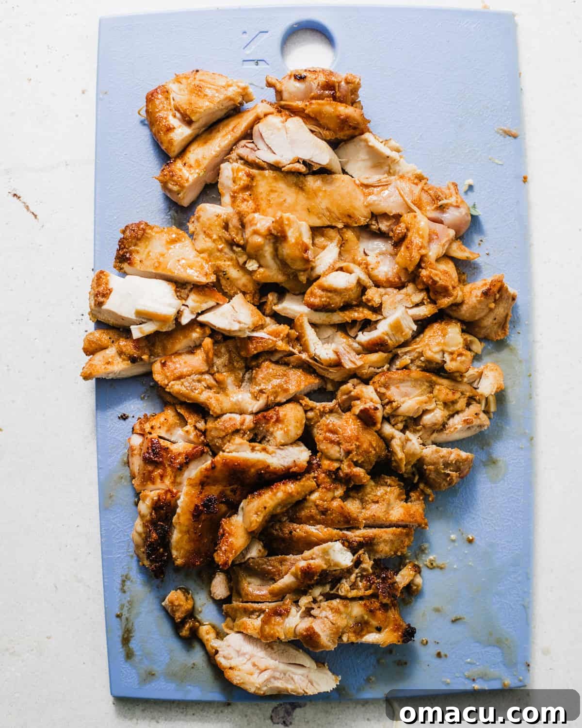 chicken chopped up on a cutting board.