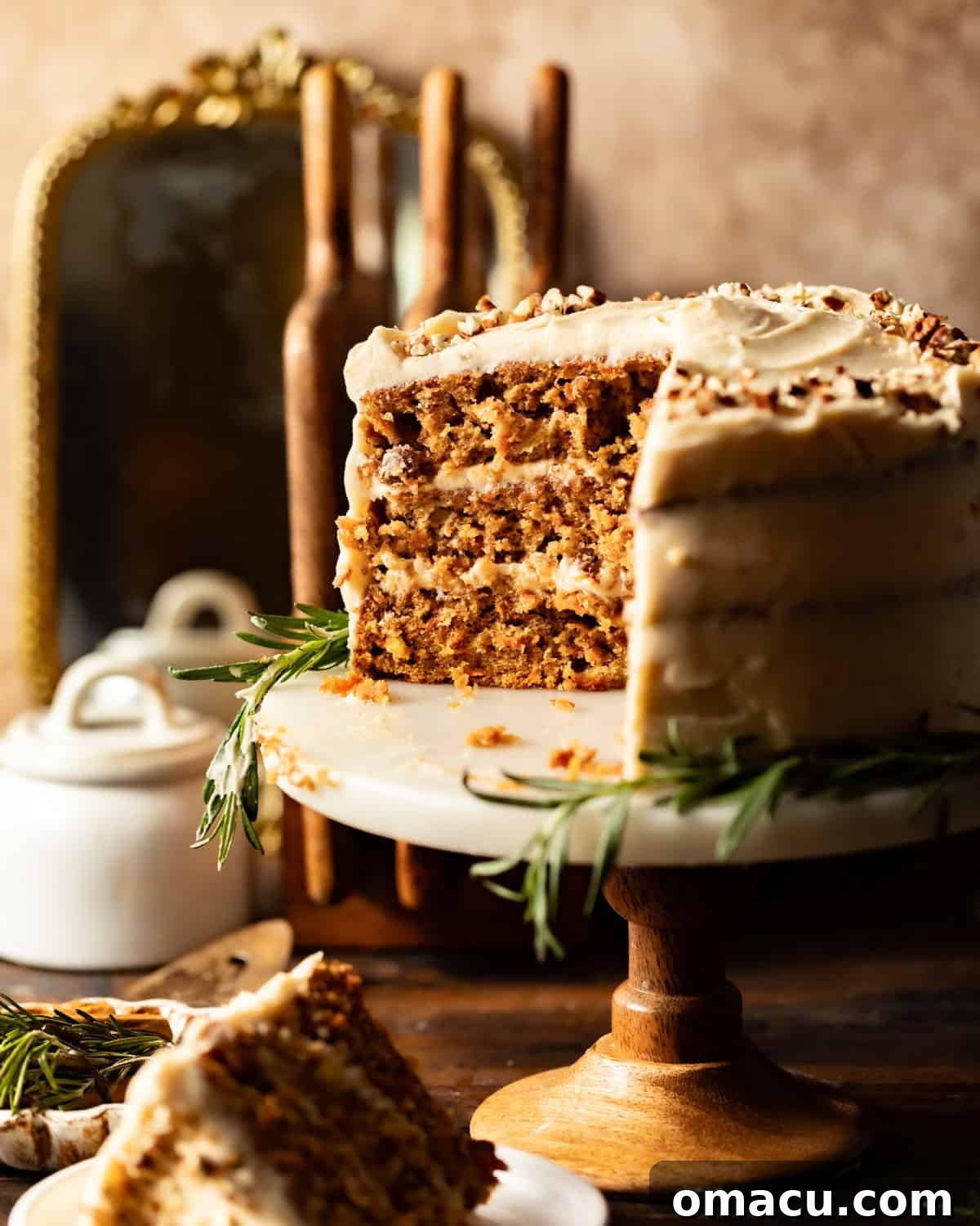A glorious sliced carrot cake on a cake stand, revealing its moist layers and creamy frosting.