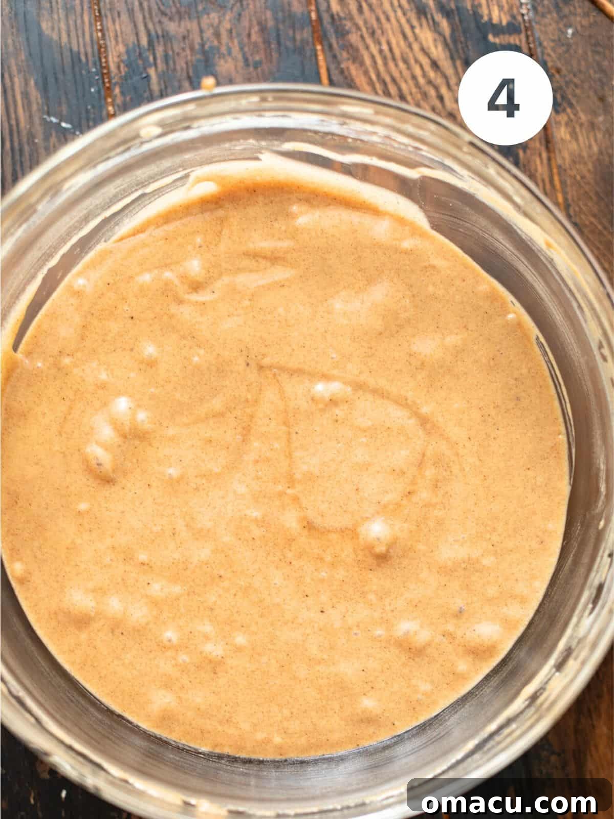 Carrot cake batter in a bowl, showing a smooth and well-combined consistency.