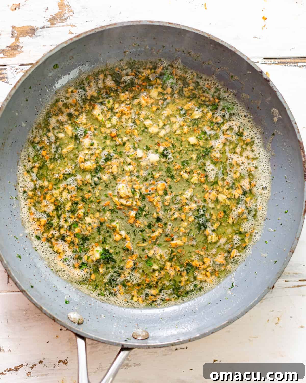 garlic butter in a skillet with parsley.