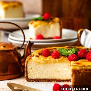 creme brulee cheesecake on a plate with fresh raspberries and a cake knife.