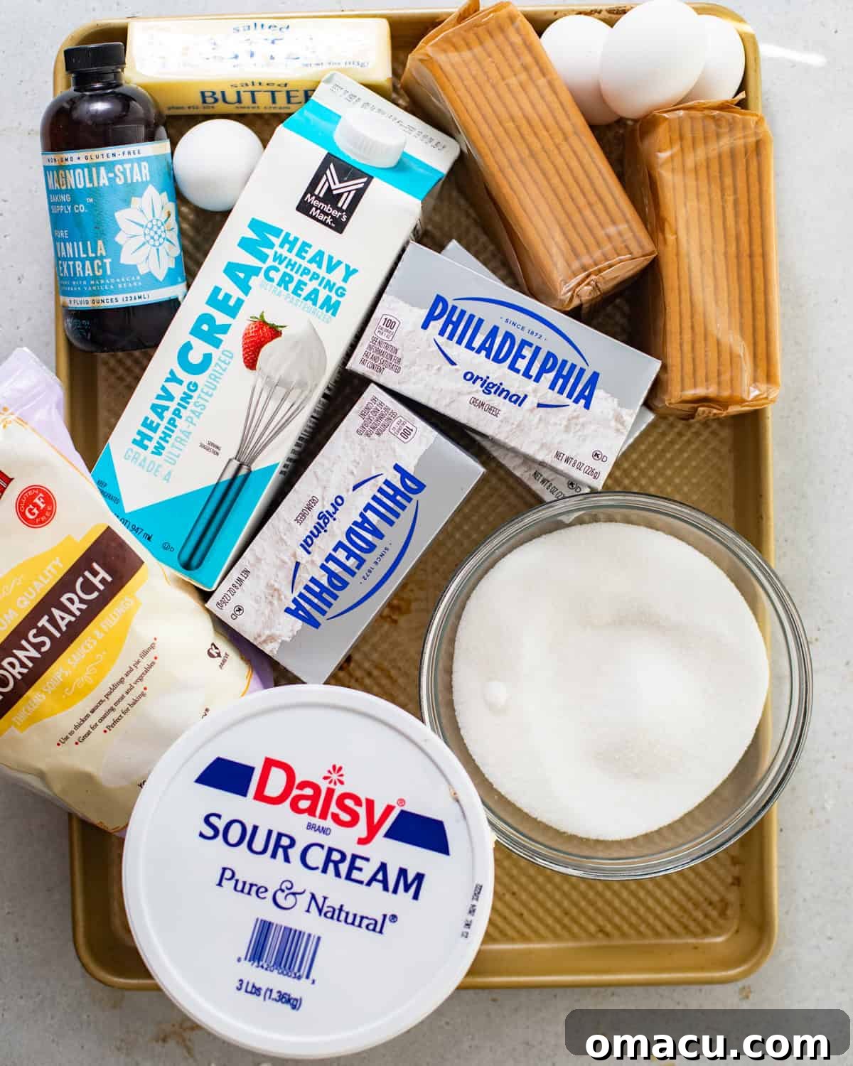 creme brulee cheesecake ingredients - cream cheese, eggs, sugar, cornstarch, sour cream, vanilla extract, butter, heavy cream, graham crackers, milk, and salt. 