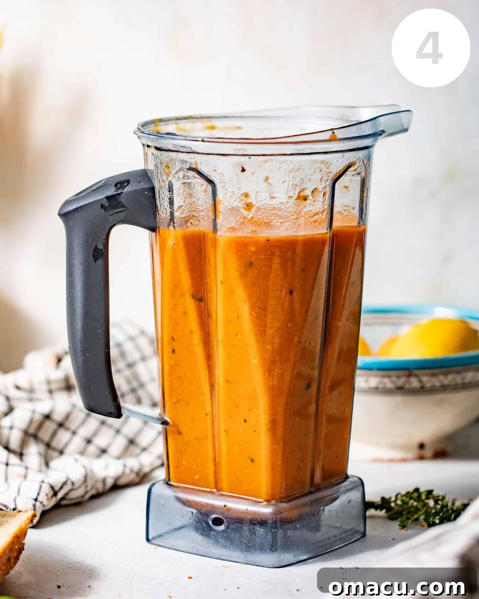 Pureed tomatoes and other roasted ingredients swirling smoothly in a blender, ready to become soup.