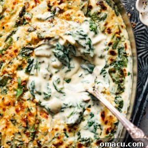 Steakhouse creamed spinach in a serving bowl with a spoon.