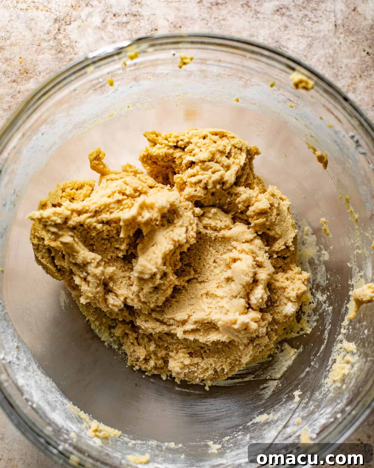 Thick snickerdoodle cookie bar batter in a mixing bowl, ready for the pan.