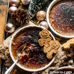 gingerbread creme brulee in a ramekin topped with gingerbread cookies on a serving tray.