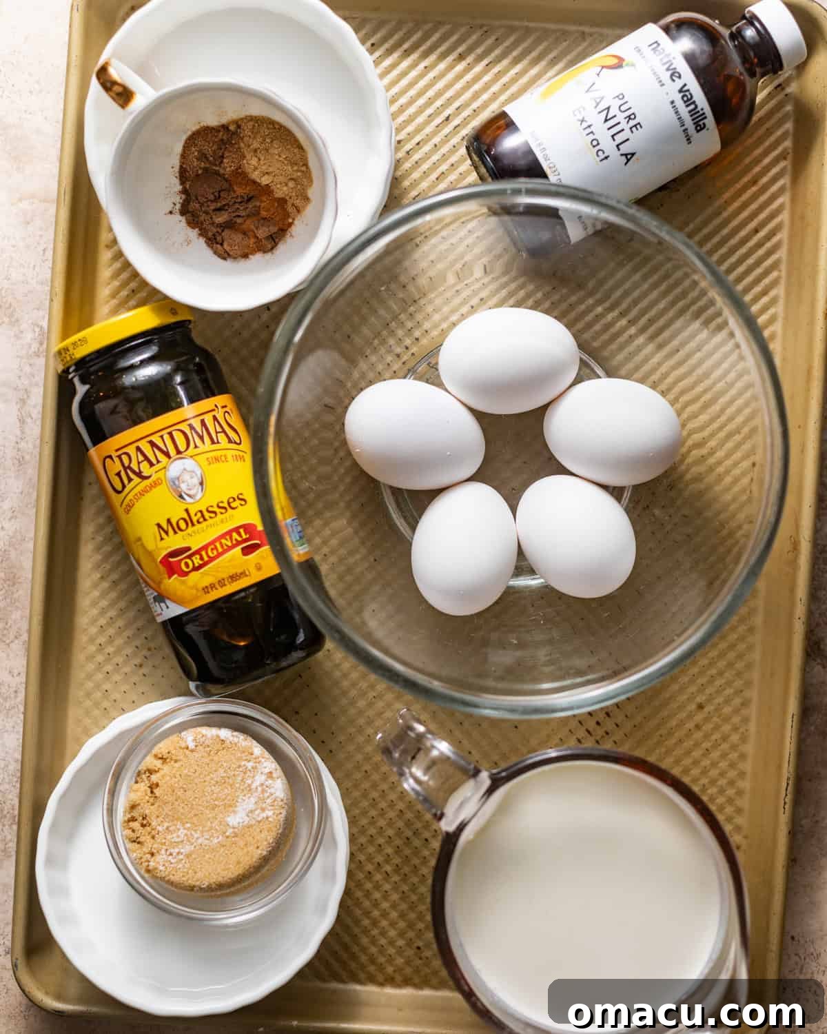 ingredients to make gingerbread creme brulee - egg yolks, spices, molasses, heavy cream, brown sugar, vanilla extract, and kosher salt.