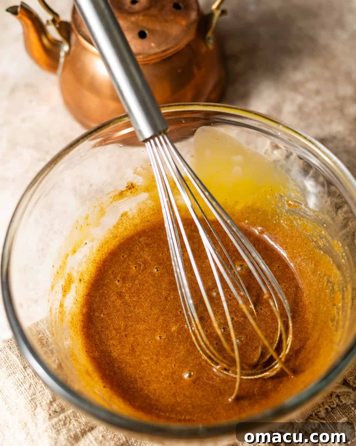 egg yolks, brown sugar, and spices whisked together in a mixing bowl. 