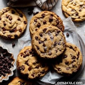 brown butter cookies on a plate with parchment paper and topped with flaky salt.