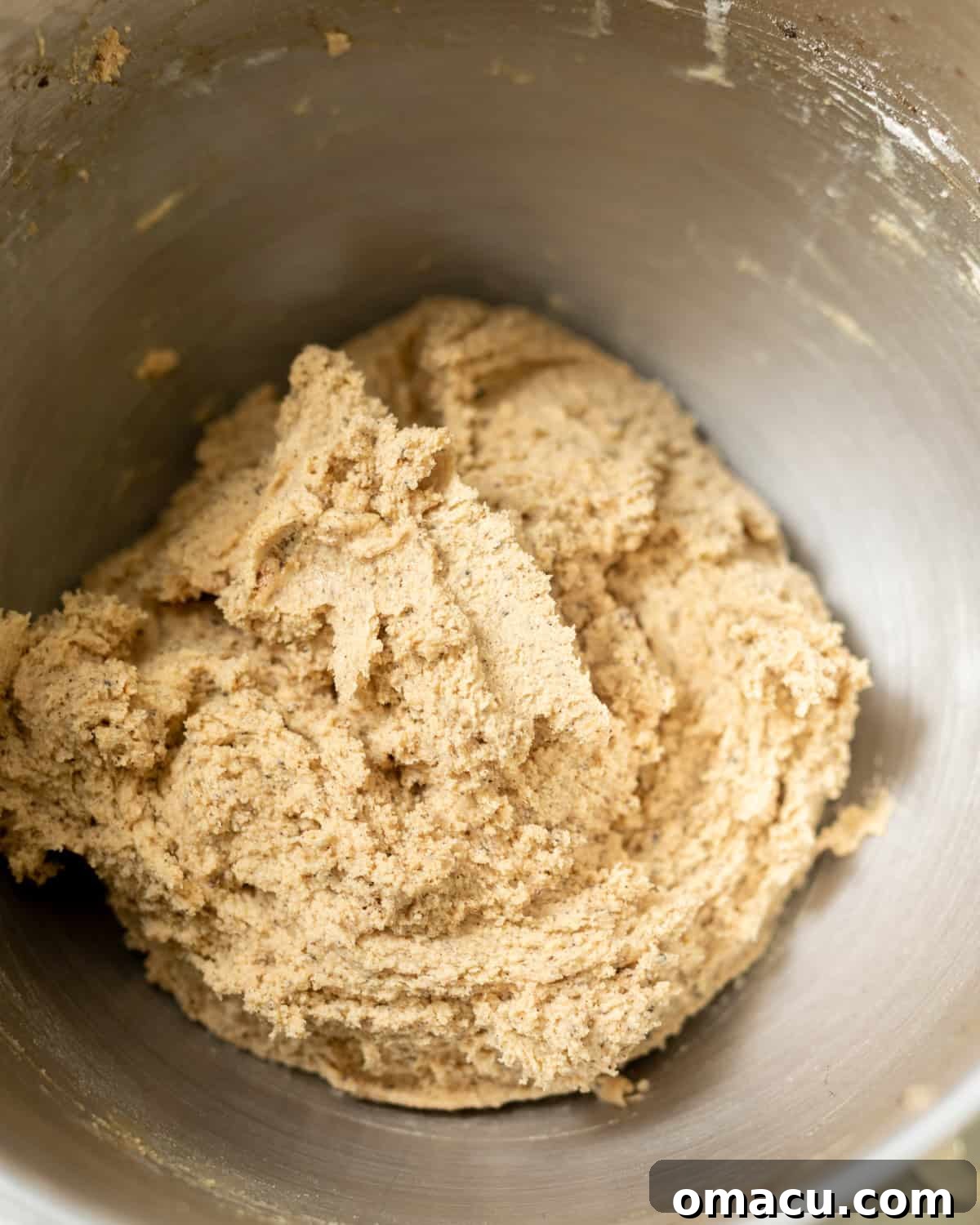 Thick, rich cookie dough with semi-sweet chocolate chips folded in, ready to be scooped and chilled.