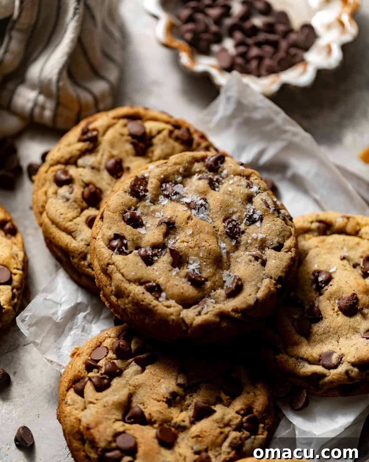 An inviting overhead shot of brown butter chocolate chip cookies, each perfectly round and golden brown, with melted chocolate visible.