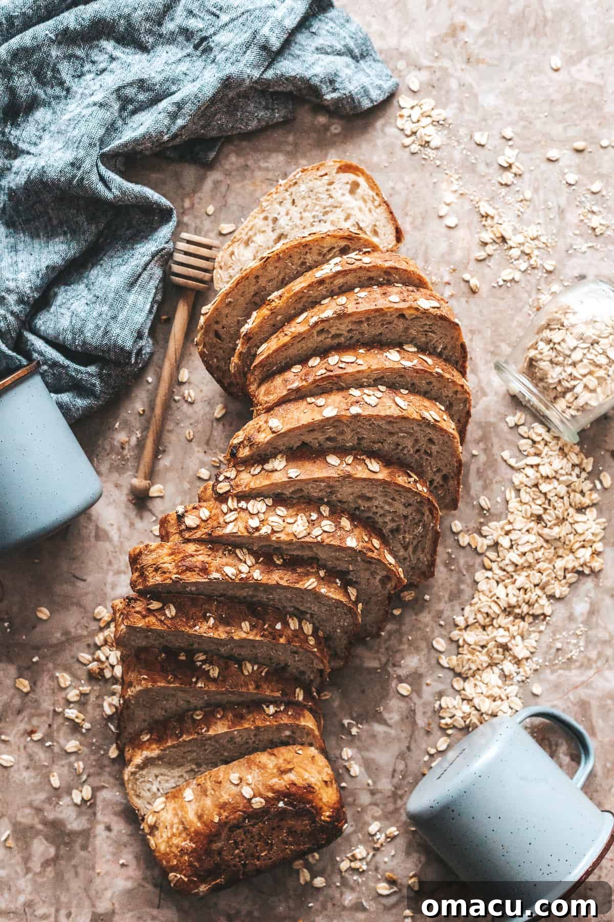 A perfectly baked and sliced loaf of Honey Oat Bread, ready to be served.