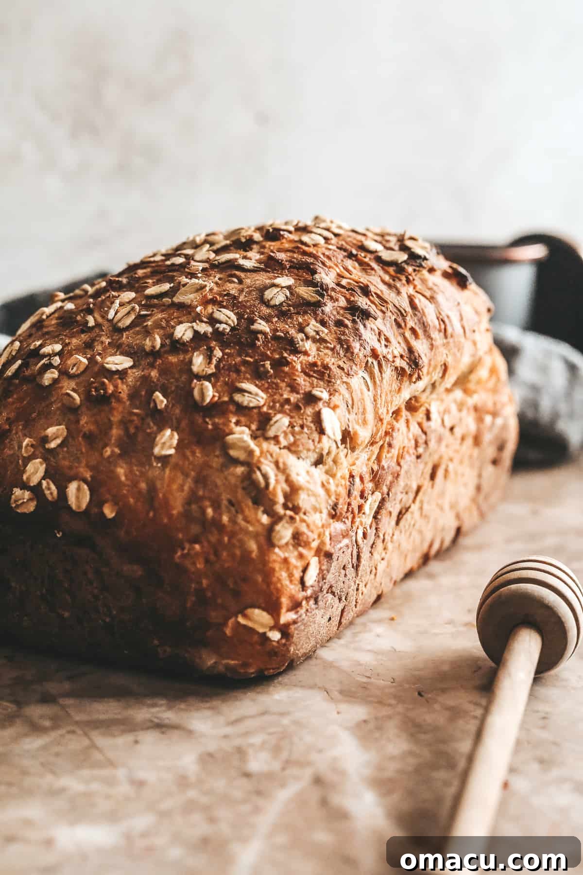 A freshly baked loaf of Honey Oat Bread, ready for slicing and enjoying.