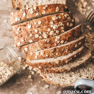 A finished loaf of Honey Oat Bread, ready to be sliced and enjoyed.