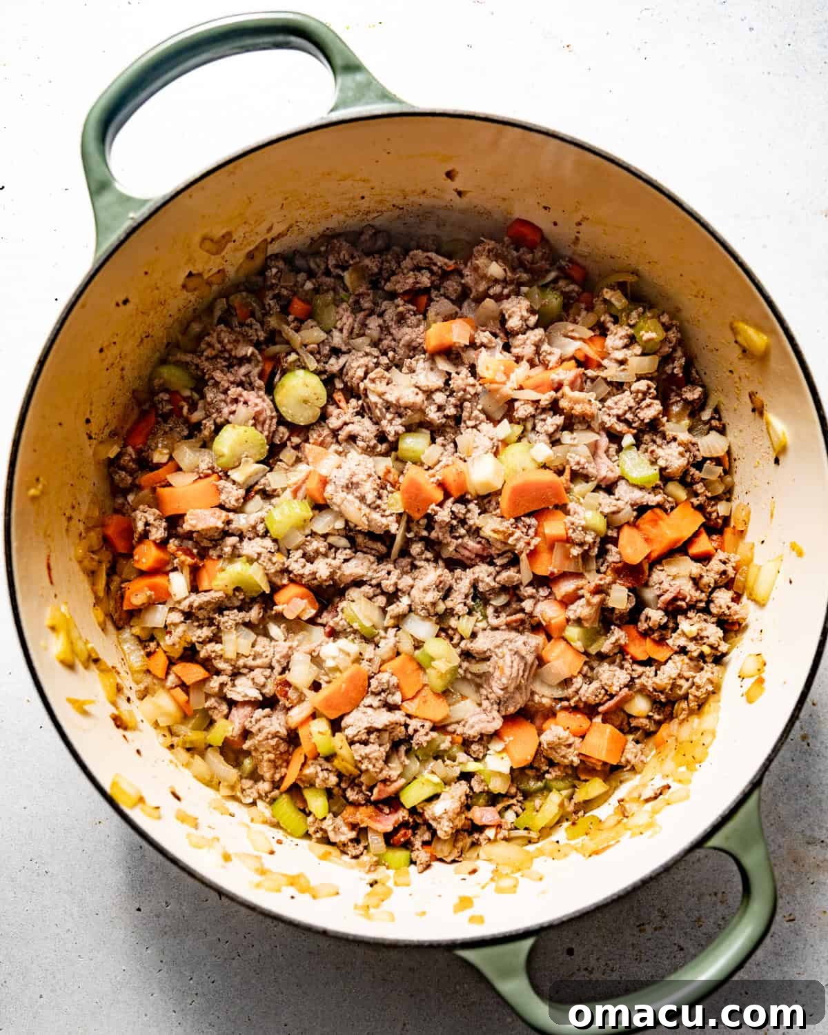 ground beef and ground pork added to the soffrito and bacon and cooked together in a large pot. 