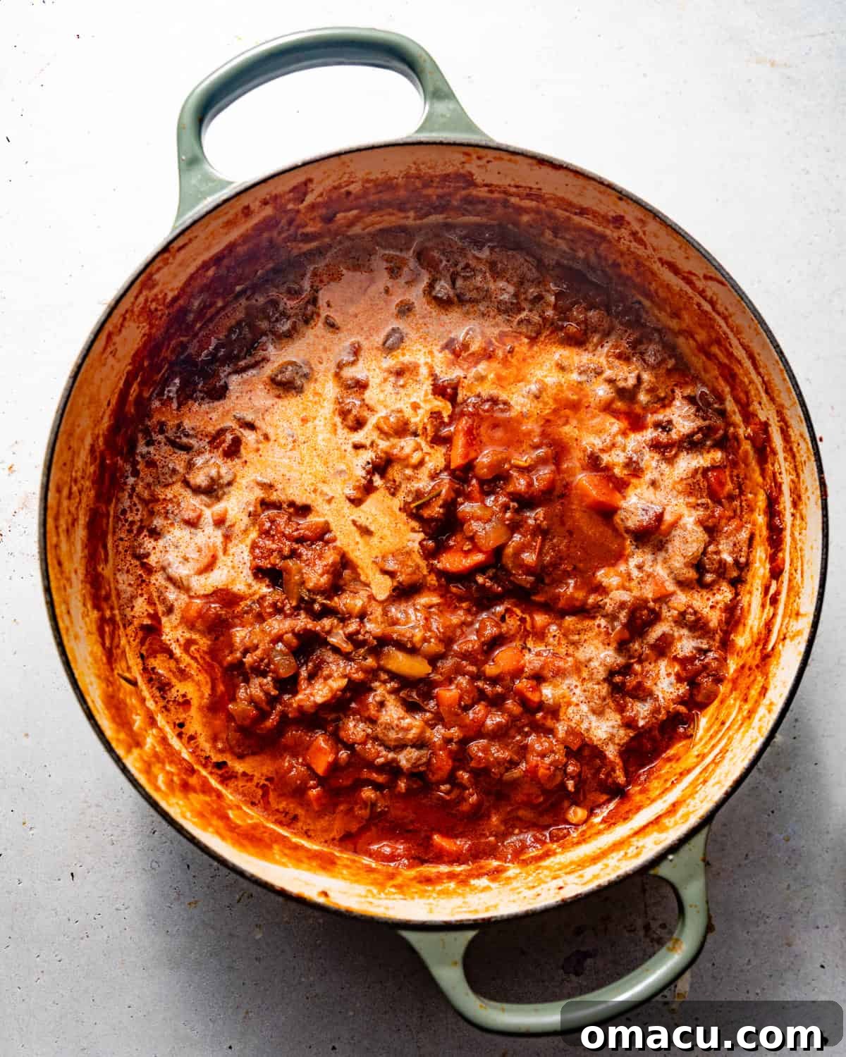 bolognese sauce in a pot with heavy cream mixed in. 