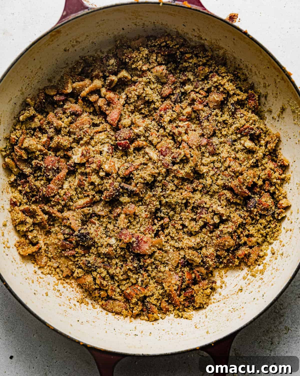 Crispy bacon pecan topping assembled in a skillet, golden brown and ready to be sprinkled.