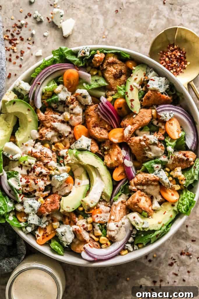 A bowl of Cajun Chicken Caesar Salad with a fork, ready to be enjoyed