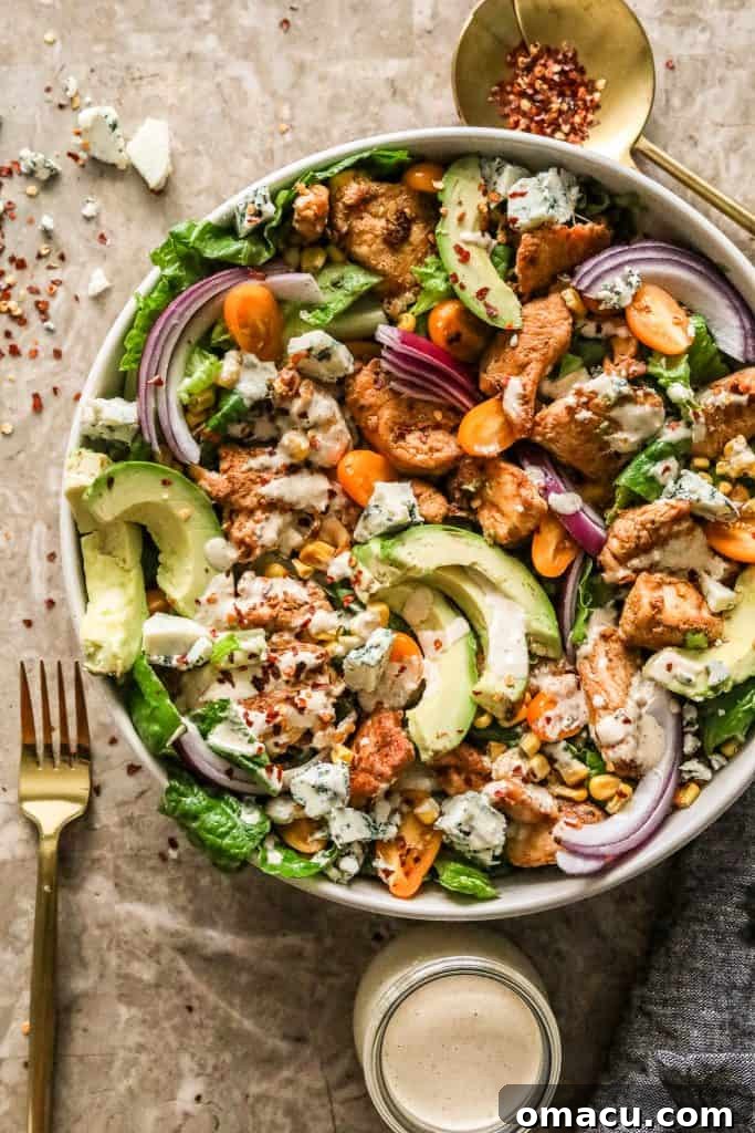 A beautifully plated Cajun Chicken Caesar Salad, garnished with Parmesan