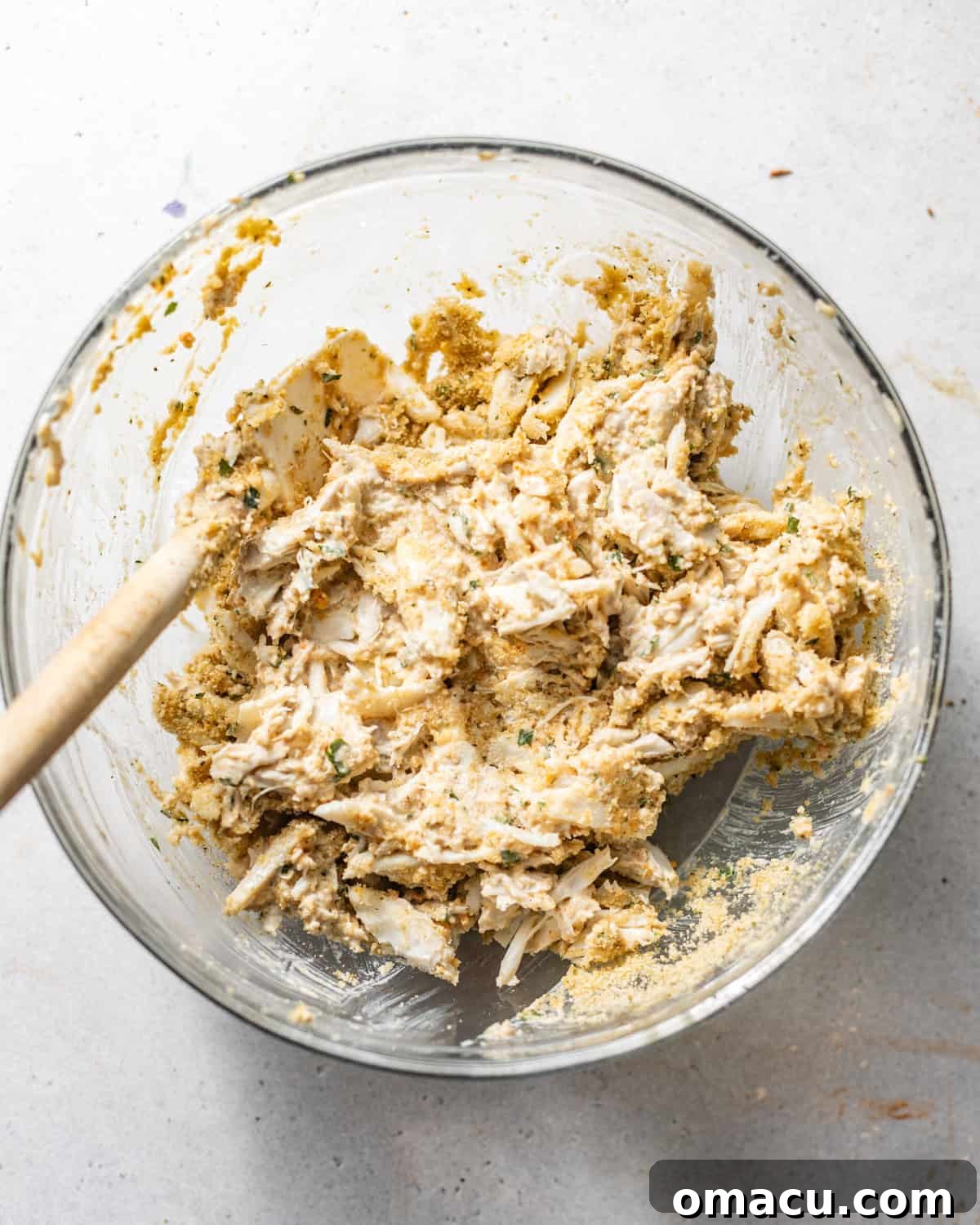 A vibrant bowl of meticulously mixed crab meat filling, showcasing its rich texture and ready to be used for stuffing.