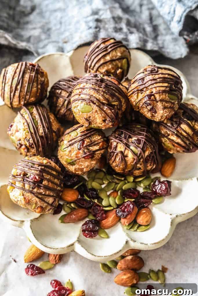 A stack of homemade no-bake mixed fruit and nut energy bites, featuring a rich blend of dried fruits and nuts, ready to be enjoyed.