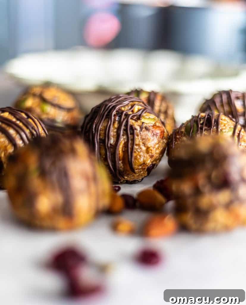 Artistically blurred background with a clear focus on a handful of mixed fruit and nut energy bites, showcasing their rustic appeal.