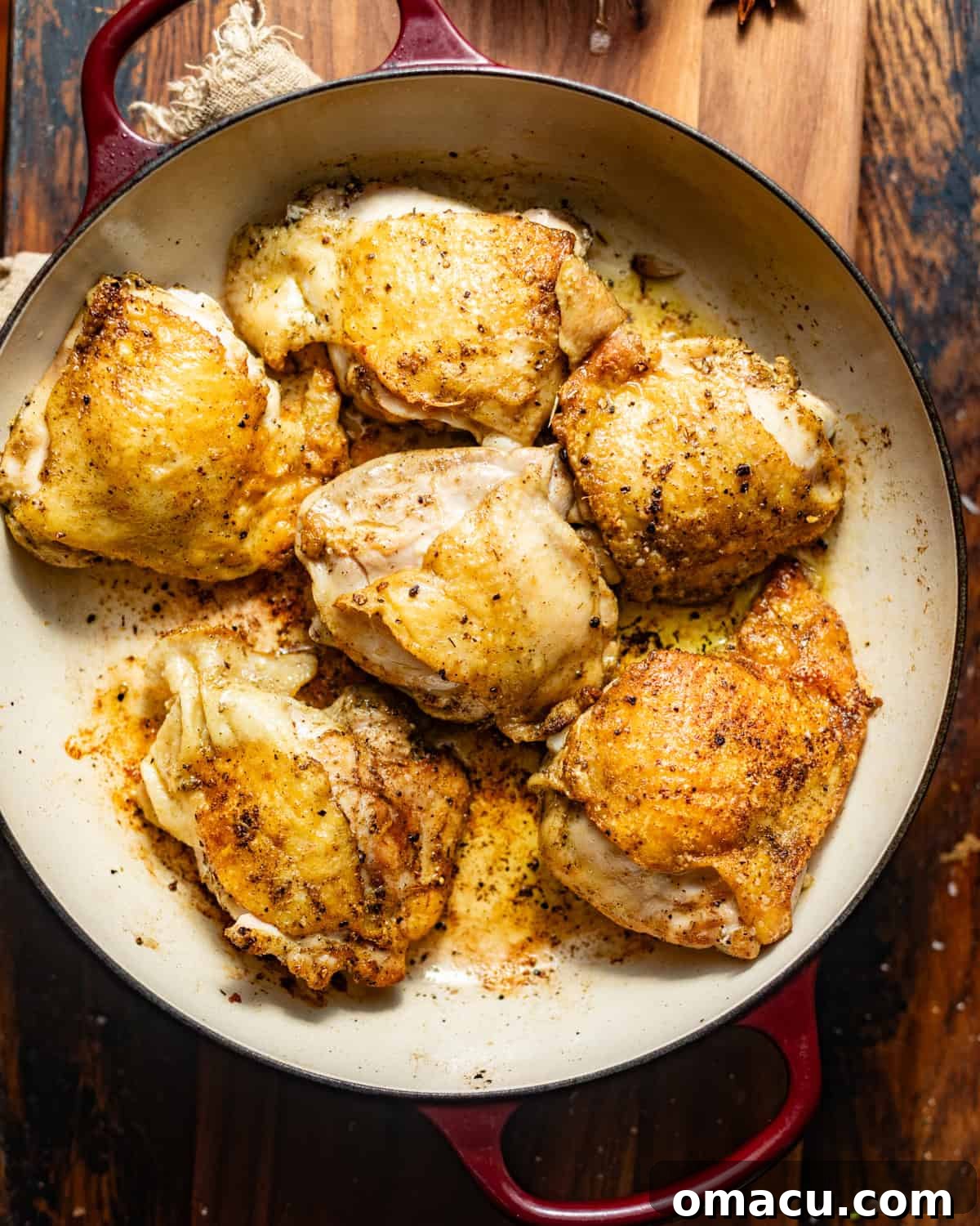 seasoned chicken thighs in a skillet.