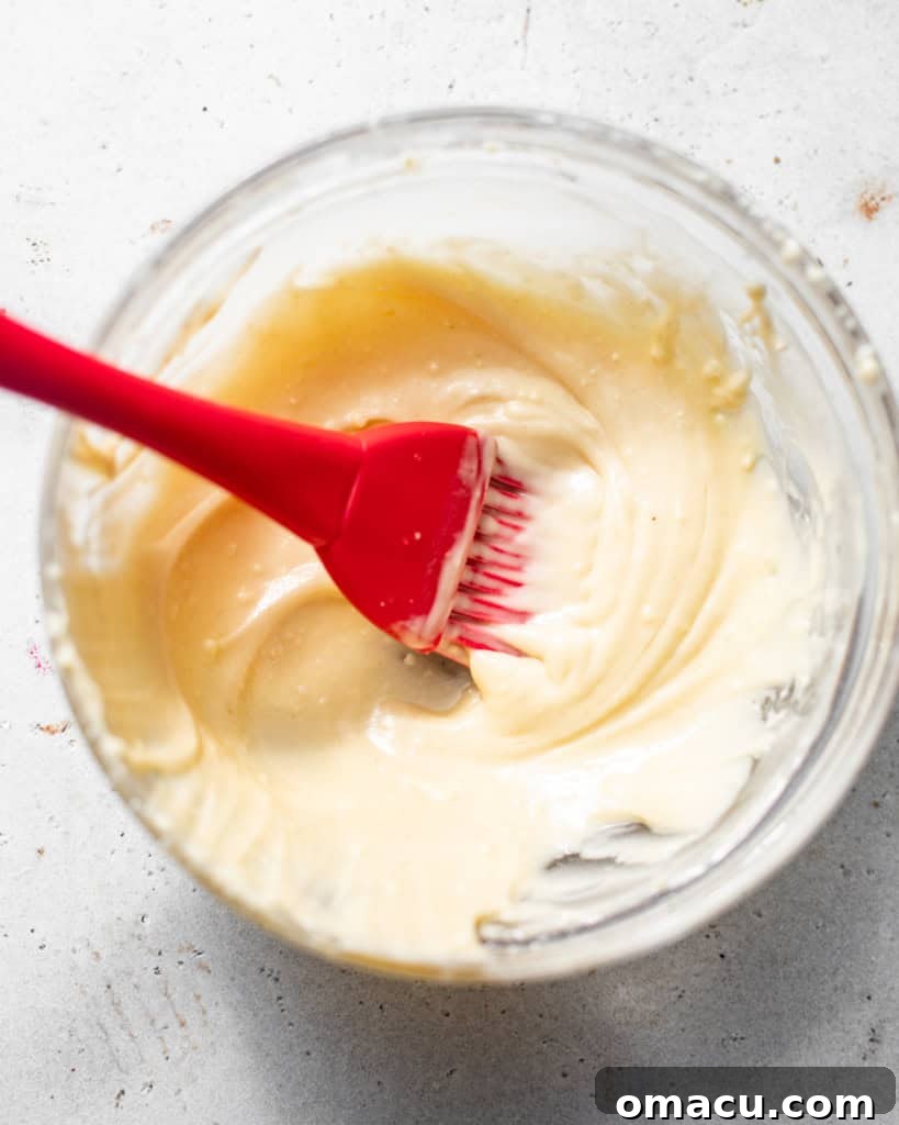 Cake release mixture being whisked together in a small bowl, showing its smooth consistency.
