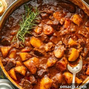Close-up photo of the rich, chunky stovetop beef stew in a pot, highlighting its hearty texture.