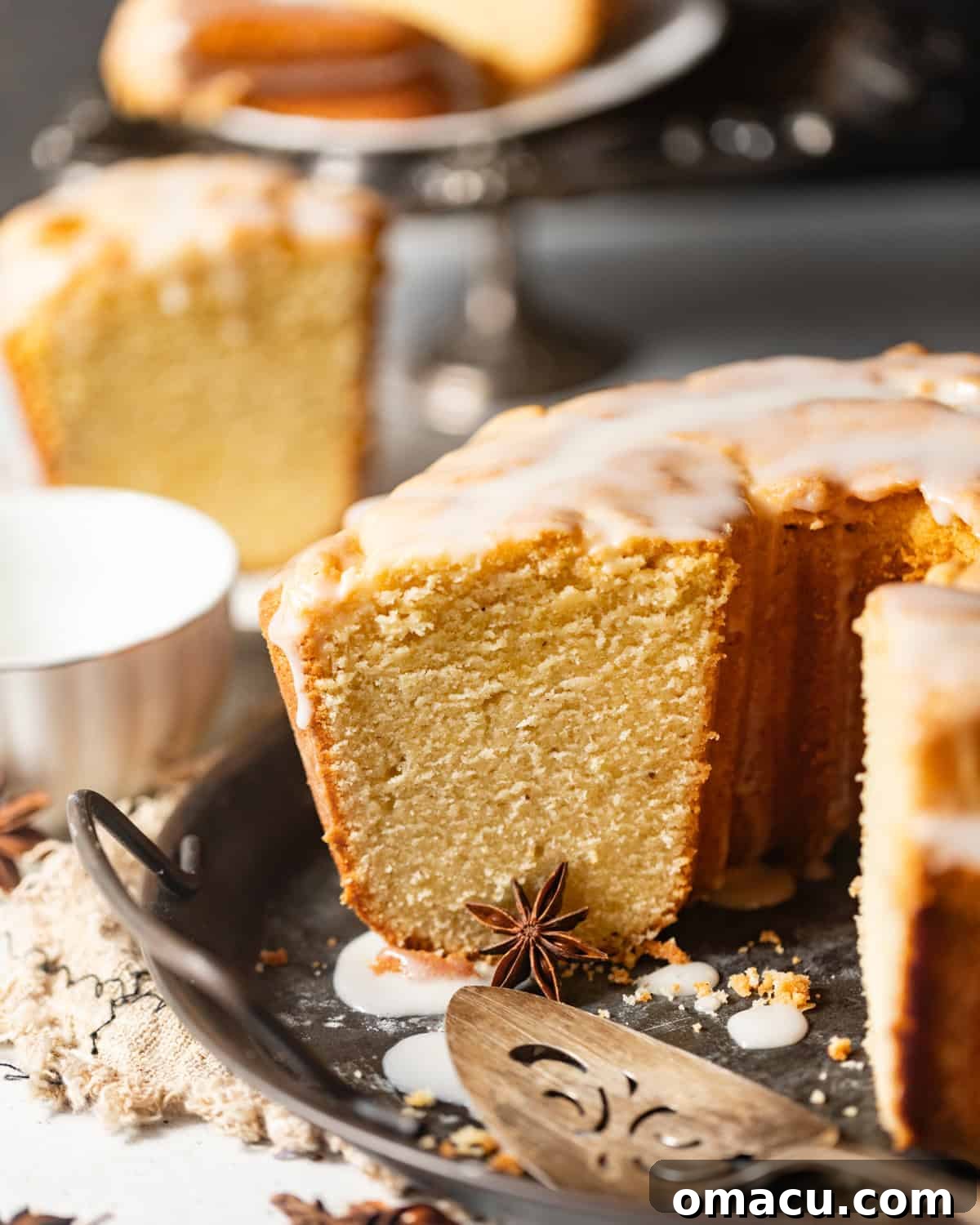 sliced donut cake on a platter with a cake server.