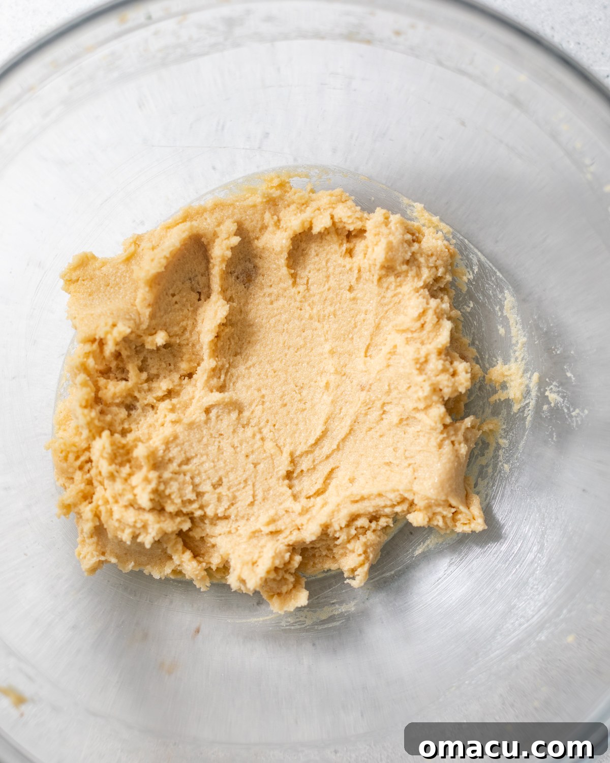 Room temperature butter, brown sugar, and granulated sugar creamed together in a medium bowl, ready for the next step.