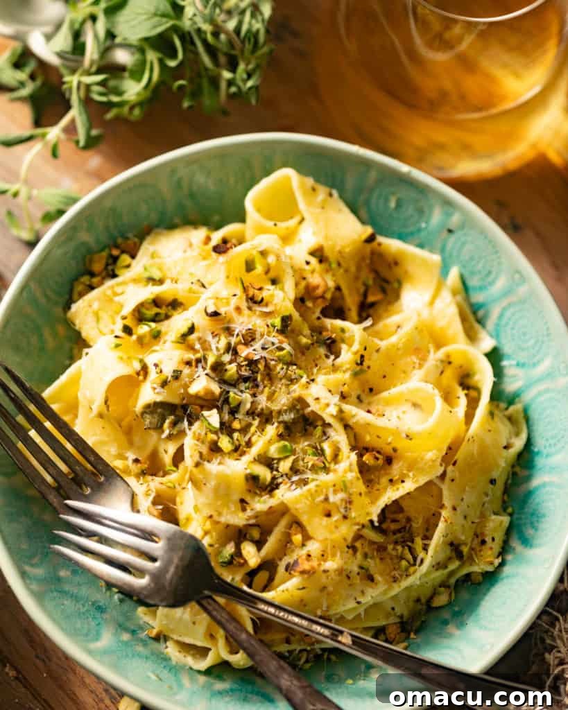 Two forks again, this time with a closer view of the lemon caper pasta in a ceramic bowl, showcasing its texture and creamy sauce.