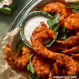 buffalo shrimp in a basket with a small bowl of blue cheese.