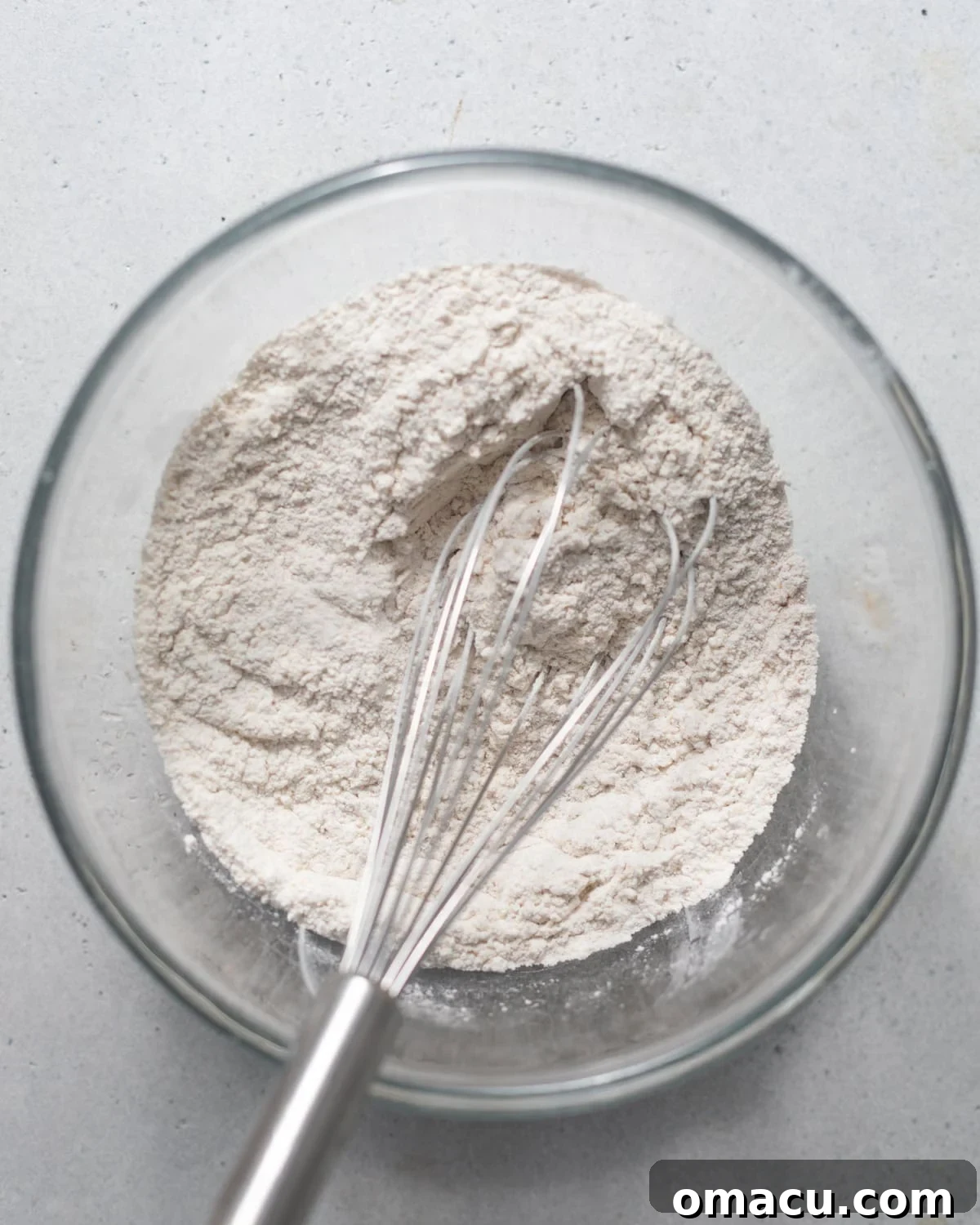 A bowl of dry flour dredge mixed with various spices.