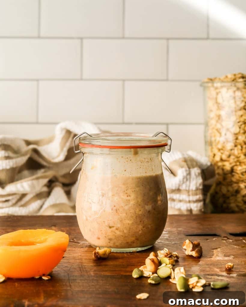 Jars of overnight oats neatly stored in a refrigerator.