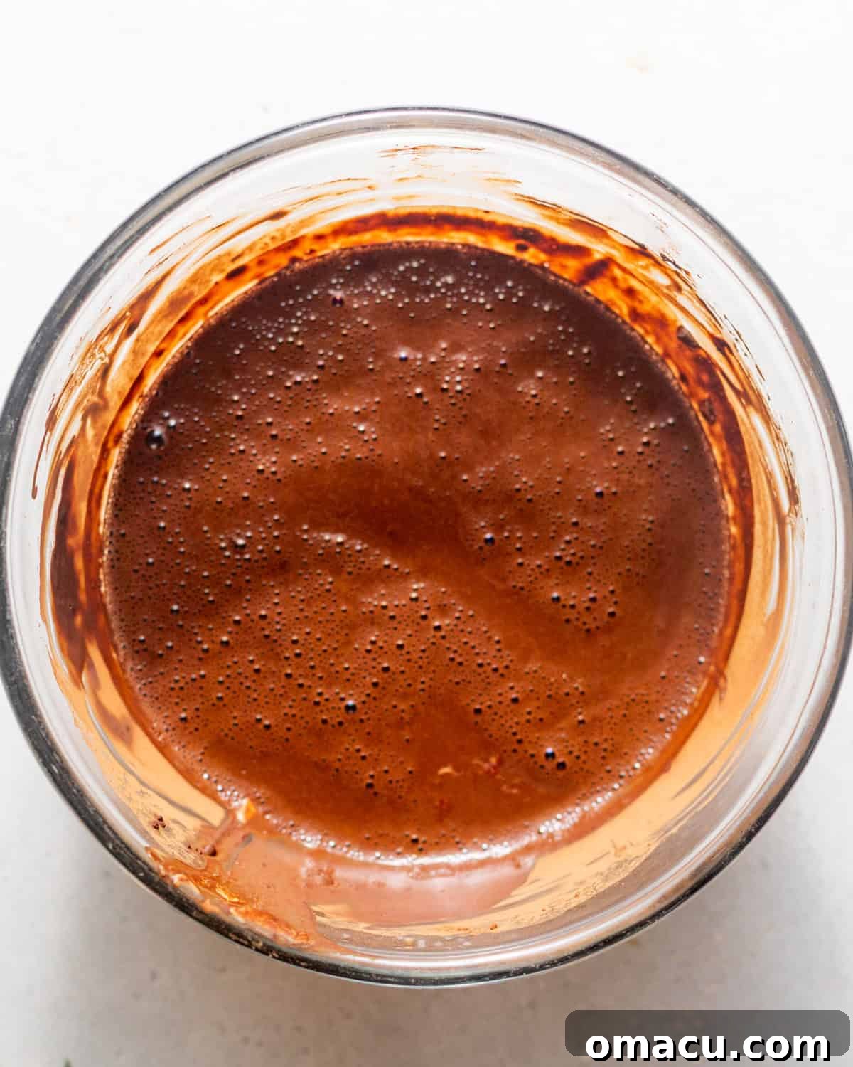 Melted butter and chocolate in a mixing bowl for chocolate mud cake.
