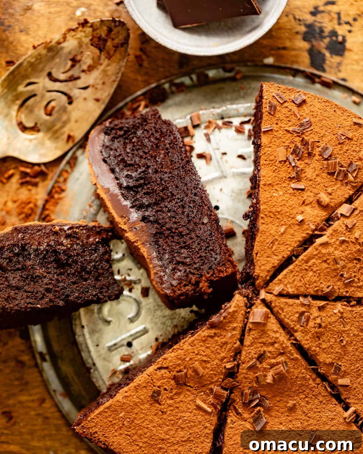 Sliced chocolate mud cake turned on its side, revealing the rich, dense, and moist interior of the cake.