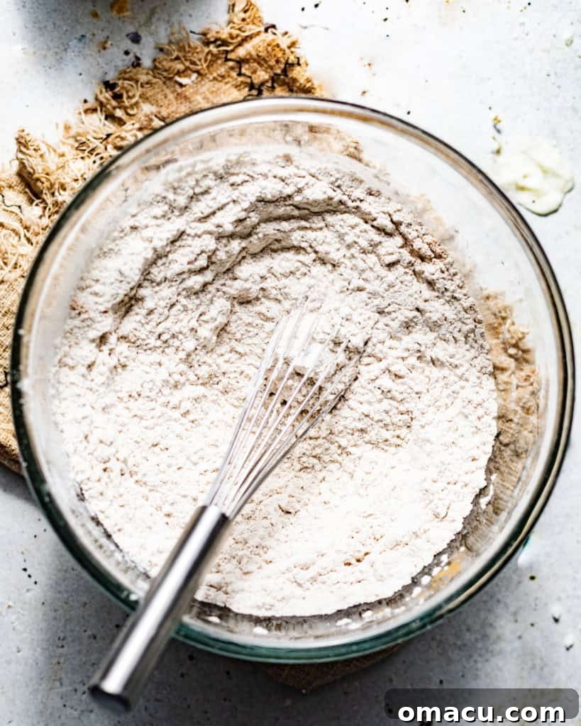 Dry ingredients for coffee cake muffins whisked together in a bowl.