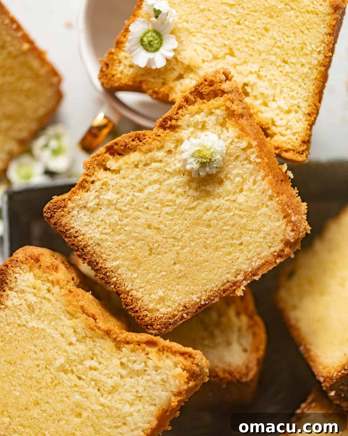 overhead photo of sliced white chocolate cake laid flat on a serving tray.