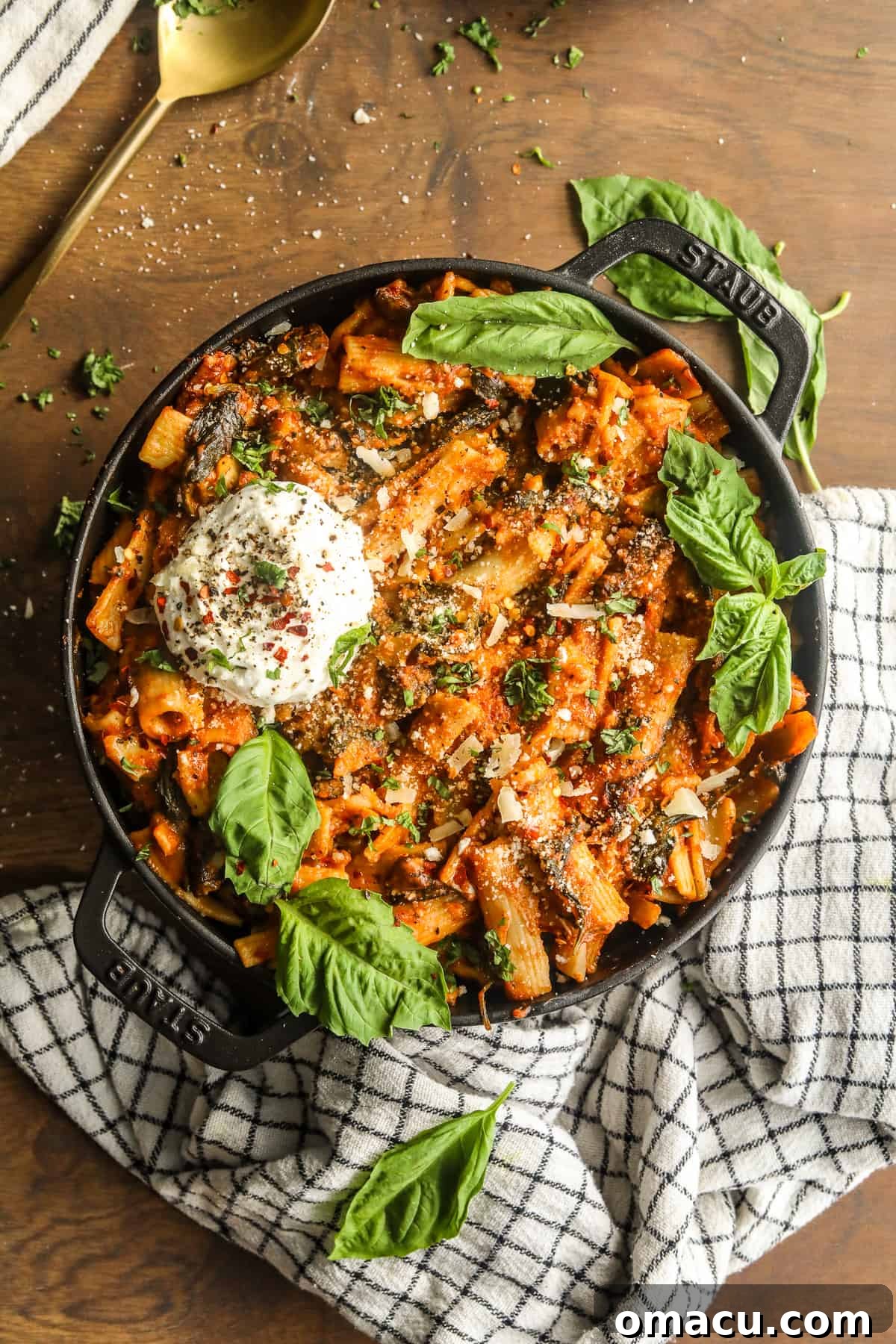 One-pot creamy tomato pasta with fresh basil leaves simmering in a large pot.